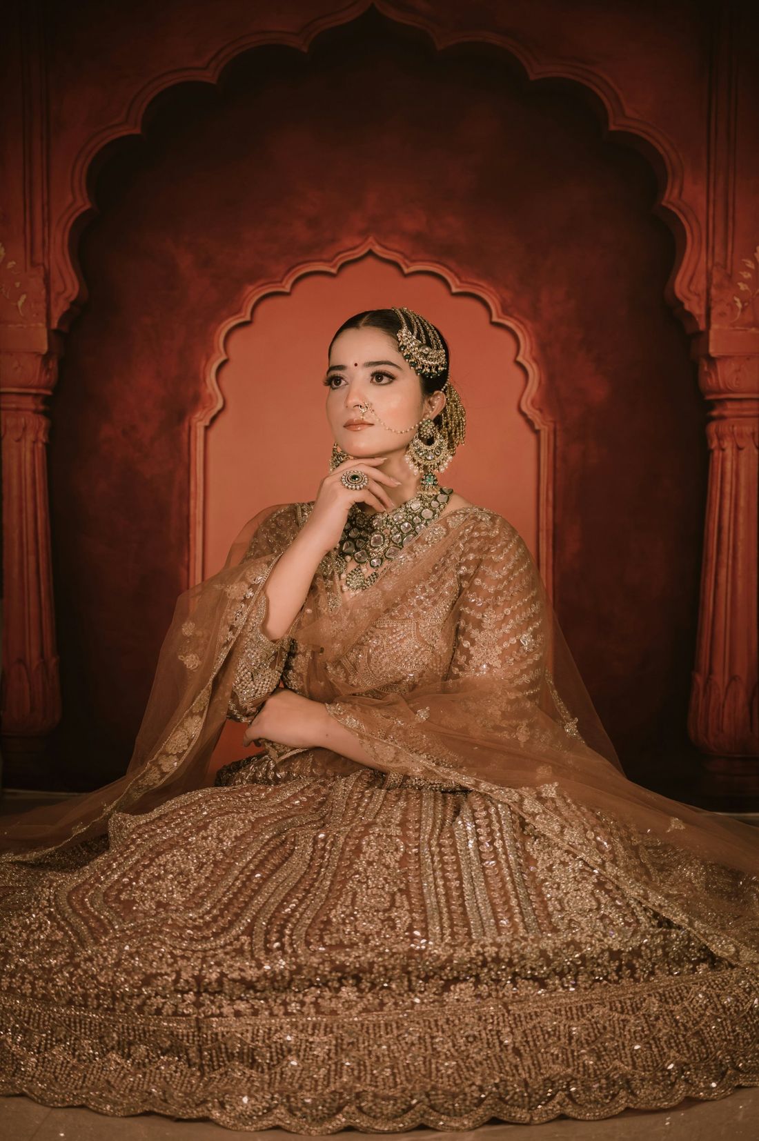 Rubina Asad store preview: a bride in a gold lehenga in front of a Mughal arch